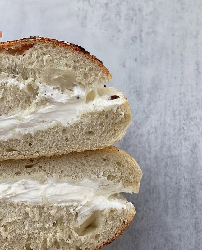 Fresh baked bagels with cream cheese at John's Bagel Deli
